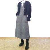 ネイビーのケーブルニットカーディガンとグレーのジャンパースカート、白タートルを合わせた50代の大人の上品トラッドコーデ